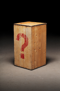 Old wooden crate with a photoshopped question mark on dirty concrete floor.